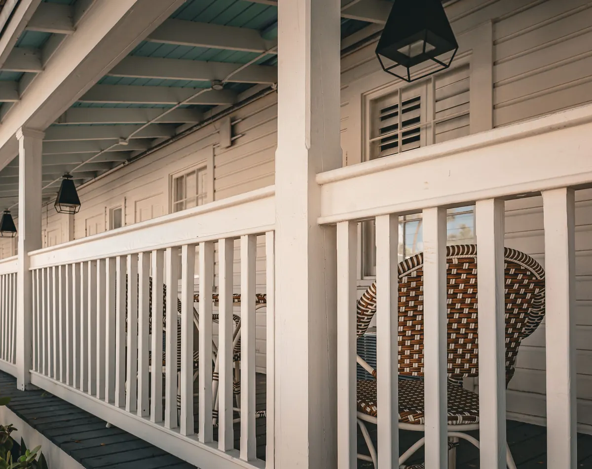 Architectural inspiration: a white clapboard porch with railings and columns