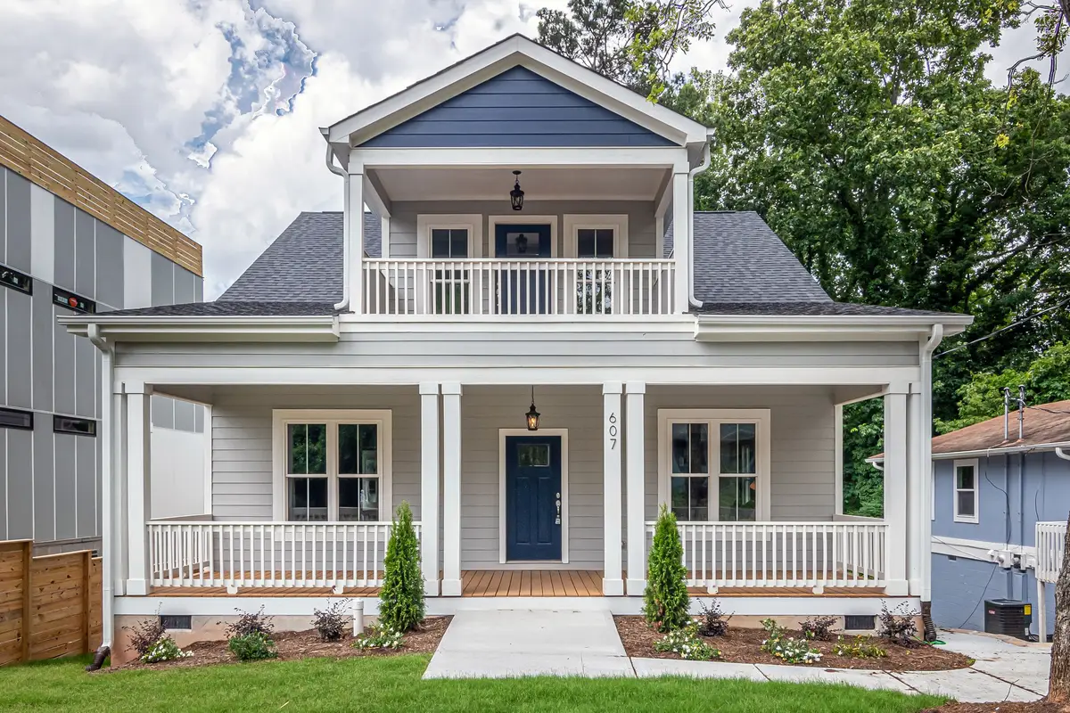 Architectural inspiration: blue-gray clapboard home with white trim and a balcony above its front porch